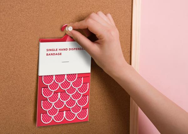 Woman's hand pinning memo to bulletin board